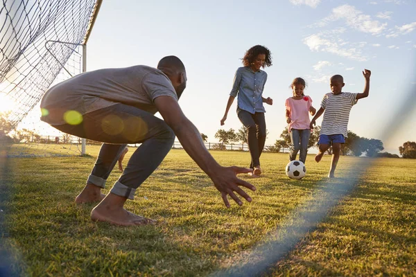 Menino chutando futebol — Fotografia de Stock