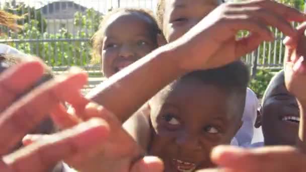 Crianças no parque infantil acenando para a câmera — Vídeo de Stock