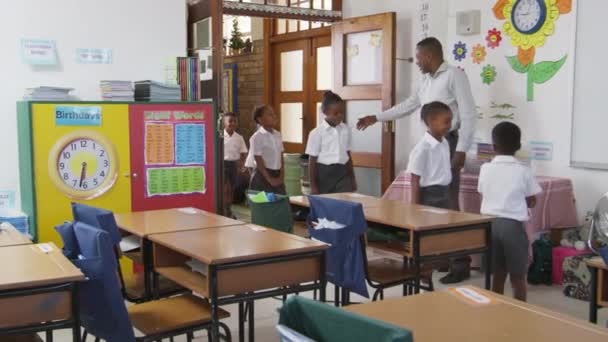 Teacher greeting kids at school classroom — Stock Video