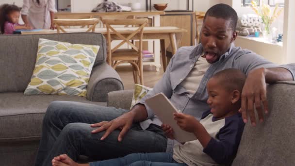 Father And Son Sit On Sofa — Stock Video