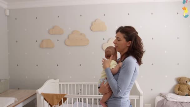 Mother Comforting Baby Son In Nursery — Stock Video