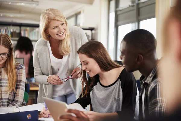 Vrouwelijke leraar werken met studenten — Stockfoto