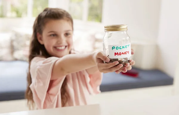 Girl Saving Pocket Money In Glass Jar — Stock Photo, Image