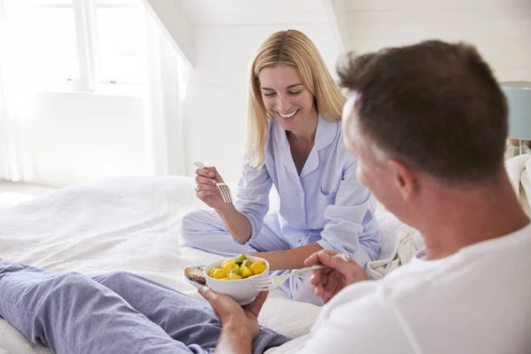 Couple Wearing Pajamas Sitting In Bed — Stock Photo, Image