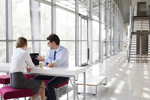 Businesswoman and businessman at meeting looking — Stock Photo, Image