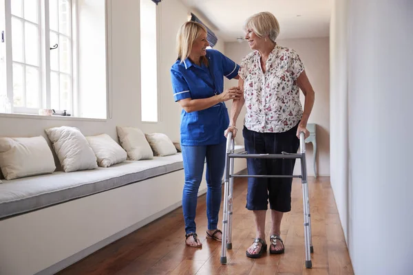 Verpleegkundige Helpen Senior Vrouw Gebruikt Een Wandelende Frame — Stockfoto