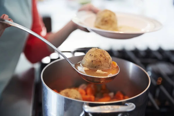 Woman Serving Jewish Matzon Ball Soup Pot Close — Stock Photo, Image