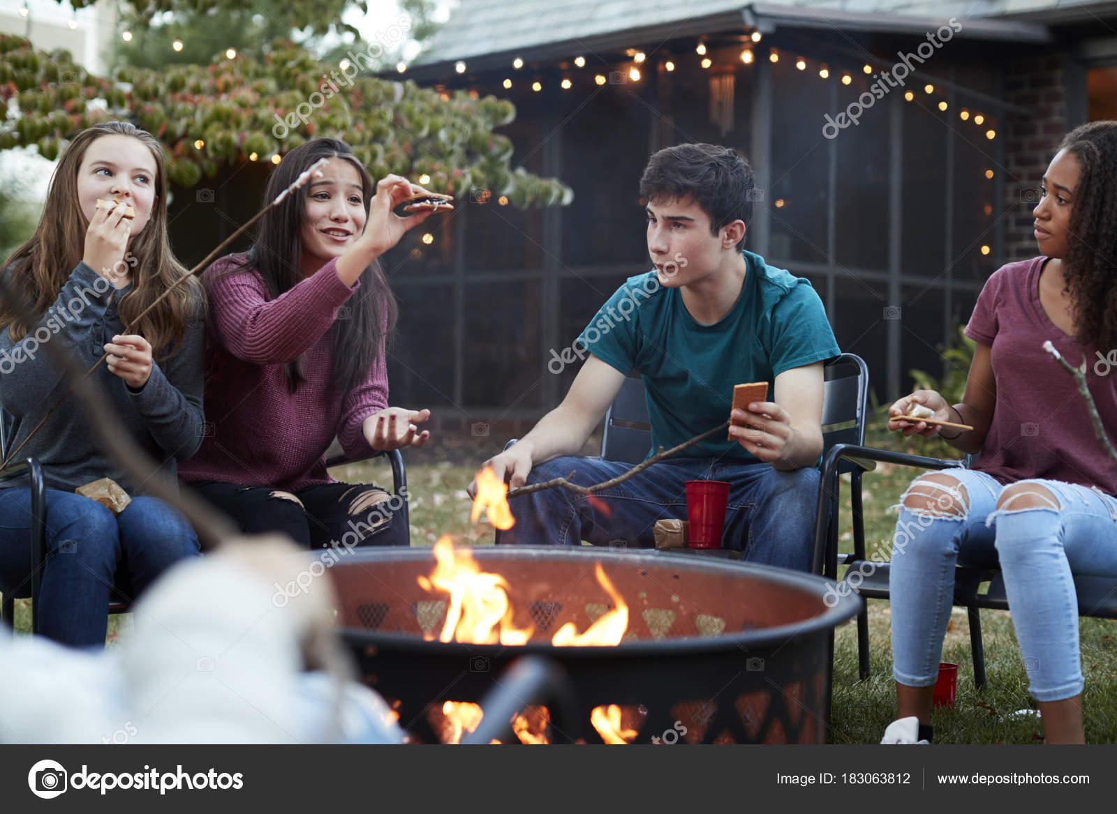 Teenage Friends Eating Smores Firepit Stock Photo Image By C Monkeybusiness 183063812