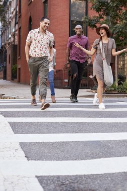 Group Of Friends Crossing Urban Street In New York City clipart
