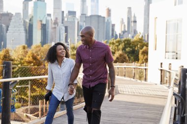 Couple Visiting New York With Manhattan Skyline In Background clipart