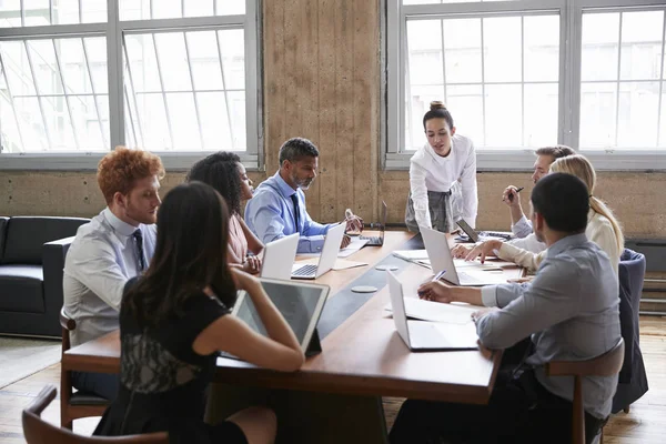 Female Manager Leans While Addressing Team Board Meeting — Stock Photo, Image