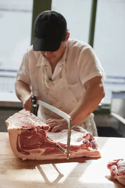 Young Butcher Sawing Meat Butcher Shop Vertical — Stock Photo, Image