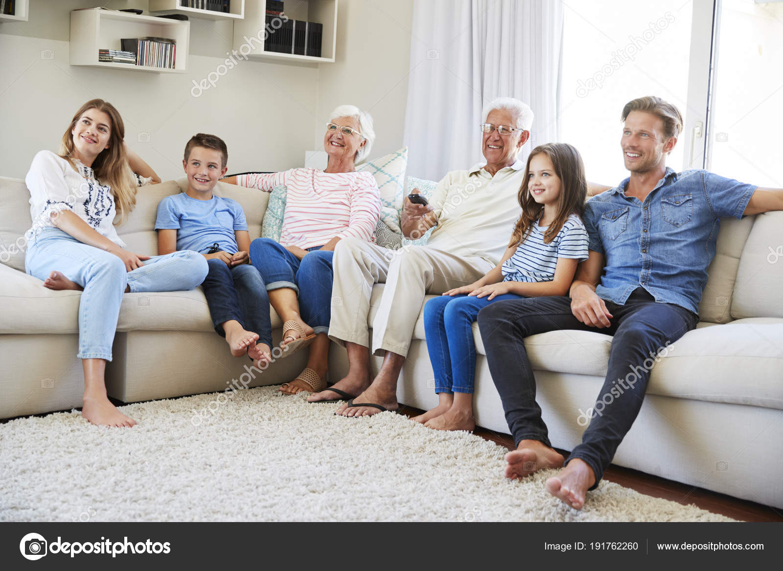 Multi Generation Family Sitting Sofa Home Watching Stock Photo C Monkeybusiness