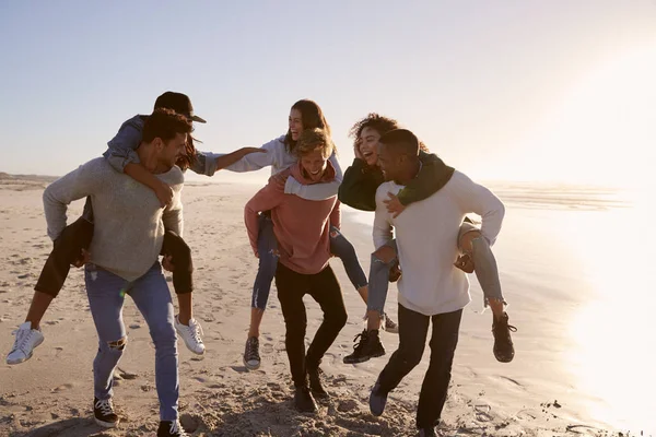 Grupo Amigos Tendo Piggyback Corrida Praia Inverno Juntos — Fotografia de Stock