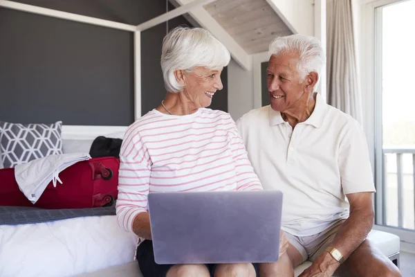 Seniorenpaar Schaut Beim Einchecken Ferienwohnung Auf Laptop — Stockfoto