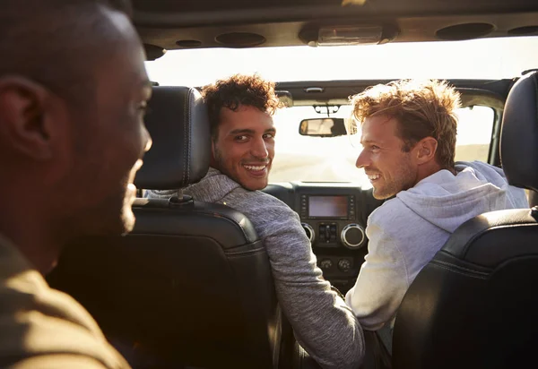 Three Young Adult Men Driving Sunroof Open Back View — Stock Photo, Image