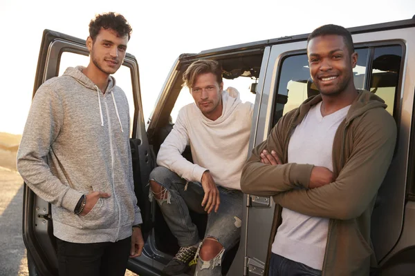 Trzech Przyjaciół Płci Męskiej Podróż Patrząc Kamery Jeep — Zdjęcie stockowe