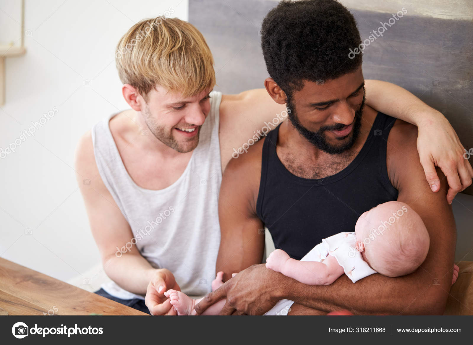 Loving Male Same Sex Couple Cuddling Baby Daughter Home Together Stock Photo by ©monkeybusiness 318211668 pic