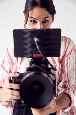 Female Videographer With Video Camera Filming Movie In White Stu clipart