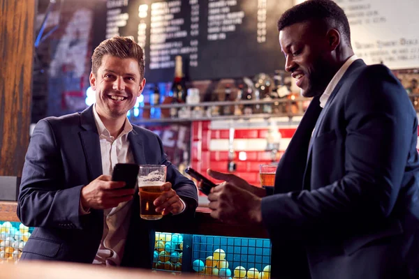 Two Businessmen Checking Mobile Phones Whilst Meeting Drink Bar — Stock Photo, Image