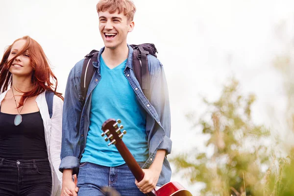 Excited Young Couple Carrying Camping Equipment Guitar Field Music Festival — ストック写真