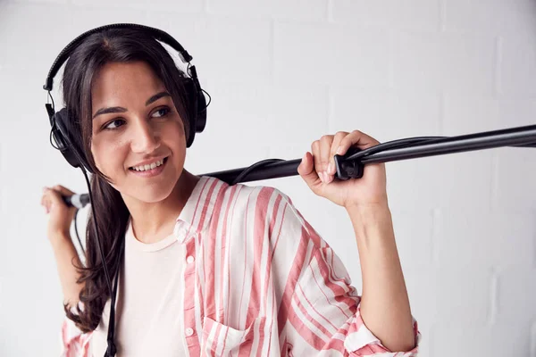 Female Sound Recordist Holding Microphone On Video Film Producti — стоковое фото