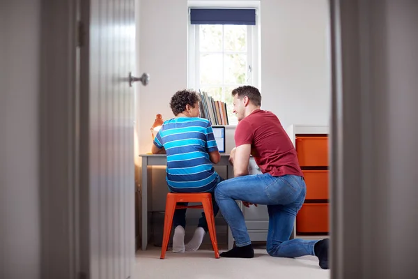 View Bedroom Door Father Helps Son Using Laptop Desk Homework — стоковое фото