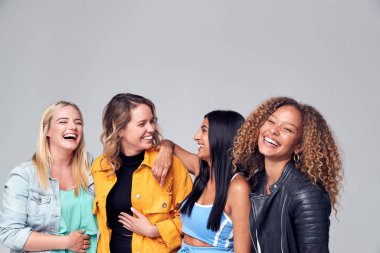 Group Studio Portrait Of Multi-Cultural Female Friends Smiling Into Camera Together clipart