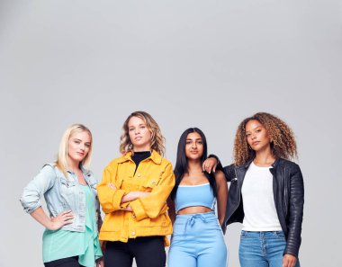 Studio Shot Of Young Independent Multi-Cultural Female Friends Looking Into Camera clipart