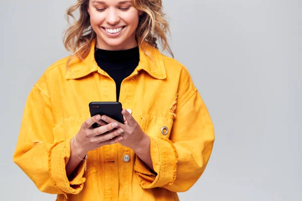 Studio Shot Smiling Causally Dressed Young Woman Using Mobile Phone — Stock Photo, Image