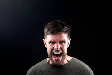 Head And Shoulders Studio Shot Of Angry Man Shouting At Camera clipart