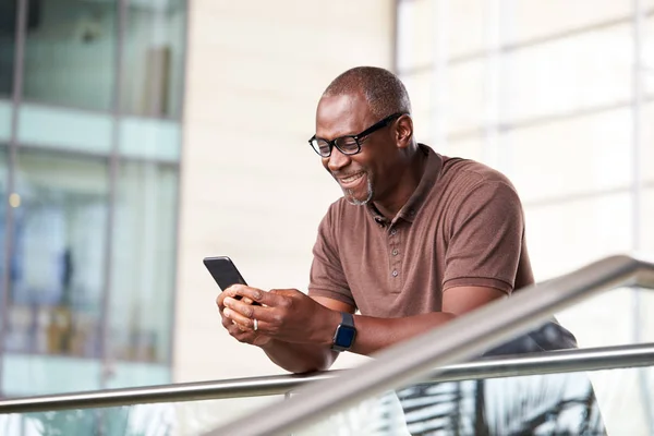 Mature Businessman Standing Lobby Modern Office Using Mobile Phone — Stock Photo, Image