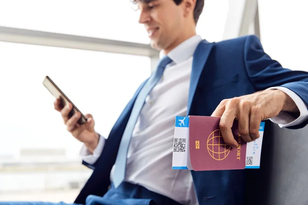 Businessman Passport Boarding Pass Sitting Airport Departure Lounge Using Mobile — Stock Photo, Image