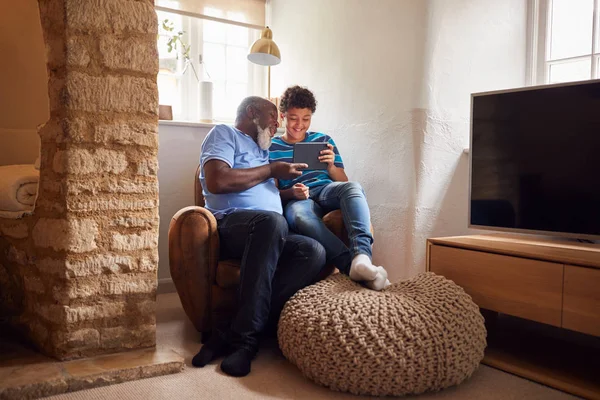 Büyükbaba Torunuyla Birlikte Sandalyede Oturup Dijital Tablette Film Izliyor — Stok fotoğraf