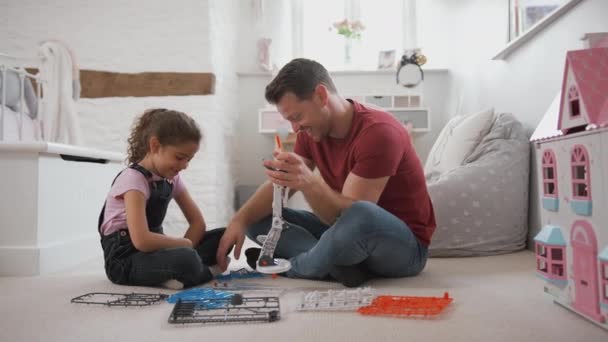 Father Daughter Sitting Bedroom Floor Building Robot Construction Kit Together — Stock video