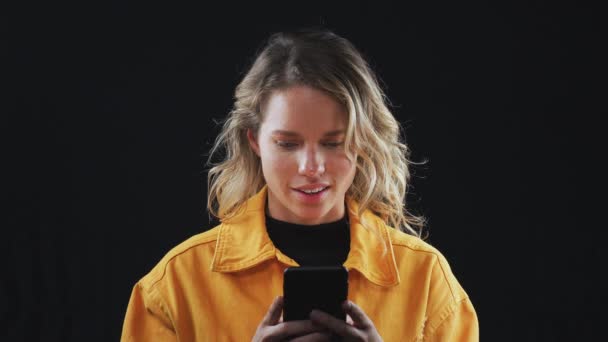 Jonge Vrouw Glimlachen Als Kijkt Naar Inhoud Gestreamd Naar Mobiele — Stockvideo