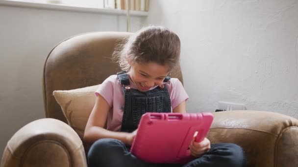 Girl Sitting Armchair Playing Digital Tablet Shot Slow Motion — Stock video