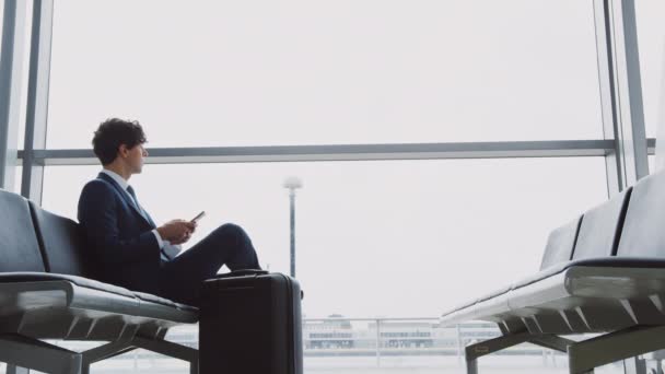 Businessman Sitting Airport Departure Lounge Luggage Using Mobile Phone Shot — Stock Video