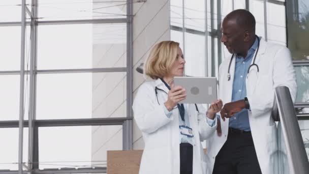 Male Female Doctors Having Informal Meeting Hospital Looking Digital Tablet — Stock Video