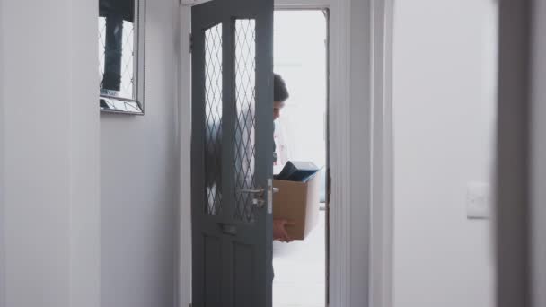 Male College Student Moving Shared House Carrying Belongings Front Door — Stock Video