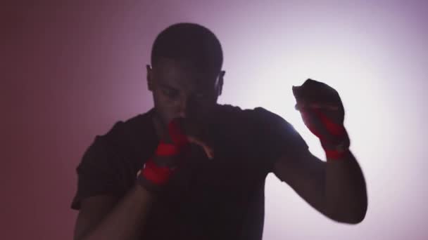 Dramatic Backlit Shot Male Boxer Gym Wearing Wraps Hands Surrounded — Stock Video