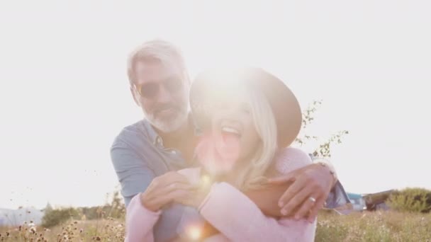 Portrait Loving Mature Couple Hugging Smile Camera Flaring Sun Shot — Stock Video