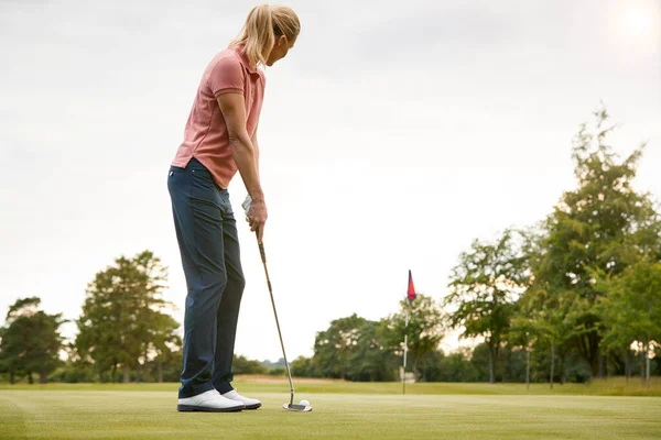 Achteraanzicht Van Vrouwelijke Golfer Putting Bal Groen — Stockfoto