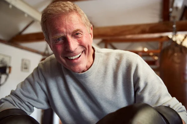 Smiling Senior Male Boxer Gym Wearing Boxing Gloves Leaning Ropes — Stockfoto