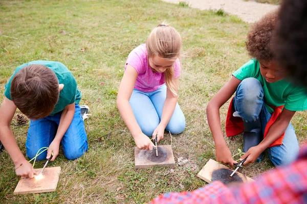 Teamleiter Zeigt Kindergruppe Auf Outdoor Campingausflug Wie Man Feuer Macht — Stockfoto