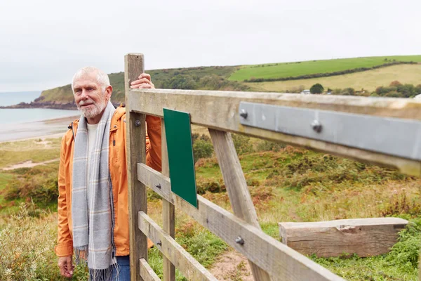 Active Senior Man Walking Coastal Path Winter Opening Gate Beach — Stock Photo, Image