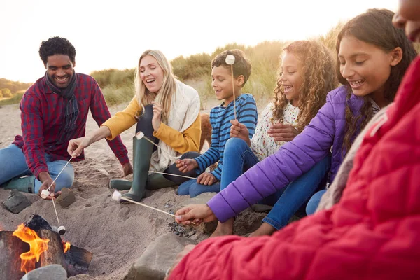 Multi Generation Rodzina Toasting Marshmallows Wokół Ognia Winter Beach Wakacje — Zdjęcie stockowe