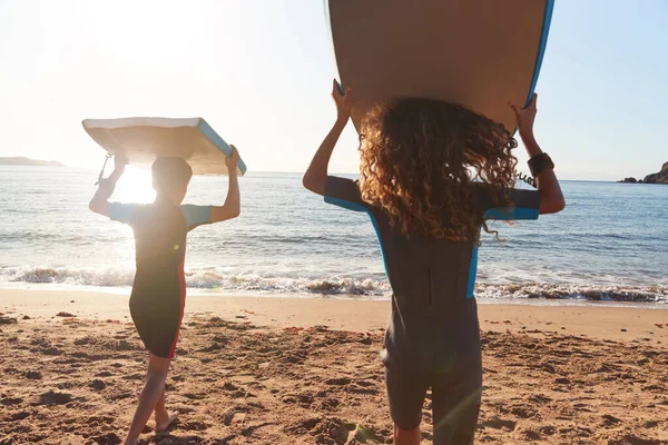 Achteraanzicht Van Kinderen Wetsuits Dragen Bodyboards Summer Beach Vakantie Hebben — Stockfoto