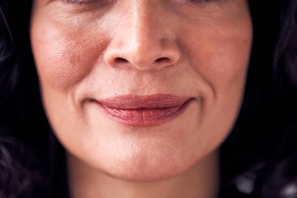 Close Up On Mouth Of Smiling Mature Woman In Studio