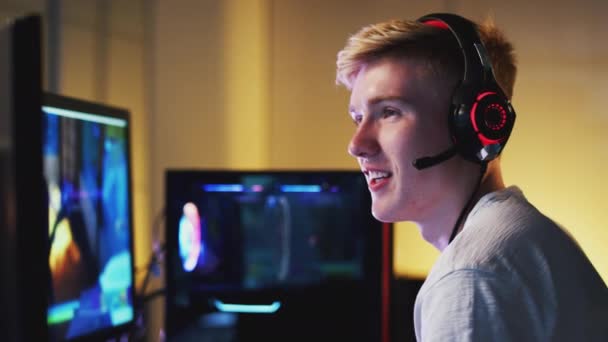 Teenage Boy Wearing Headset Sitting Front Dual Computer Screens Home — Stock video